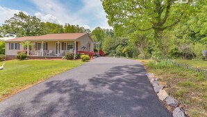 A two-story house with a porch, a driveway, and a tree in the foreground. - Peaceful Chatham Home w/ Grill & Deck (Chatham)