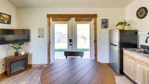 A modern kitchen with a dining area, built-in appliances, and a view to the outdoors. - Pet-friendly Elmo Home w/ Mountain & Lake Views! (Elmo)