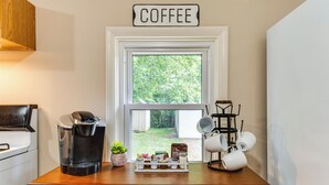 A kitchen with a coffee maker, a coffee station, and a sign that reads "COFFEE". - Peaceful Franklin Cottage ~ 1 Mi to Downtown! (Franklin)