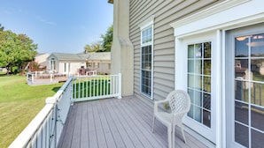 A wooden deck with a white railing, a white plastic chair, and a view of a neighboring house. - Charming Pennsylvania Retreat w/ Deck & Fireplace! (Willow Street)