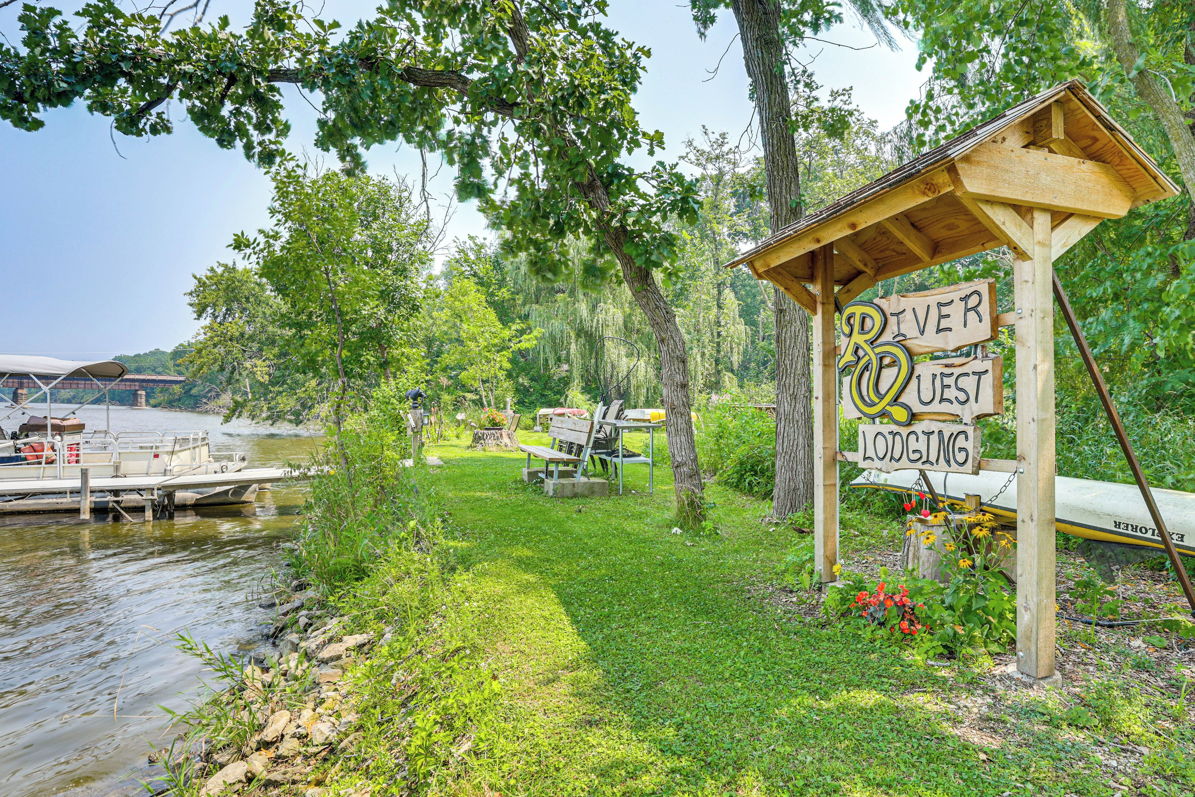 A riverside lodging area with a wooden sign indicating 'River West Lodging'.