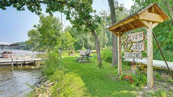 A riverside lodging area with a wooden sign indicating 'River West Lodging'.