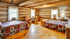 A log cabin room with two beds, wooden floors, and a rustic ambiance. - Historic Cabin Retreat ~ 2 Mi to Seneca Rocks! (Seneca Rocks)