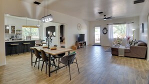 A spacious living area with a dining table, sofas, and a TV. - 14 Mi to Dtwn: Tucson Escape w/ Patio! (Tucson)