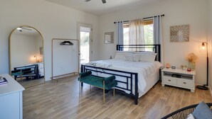A bedroom with a bed, a bench, a bedside table, a mirror, a ceiling fan, and a nightstand. - 14 Mi to Dtwn: Tucson Escape w/ Patio! (Tucson)