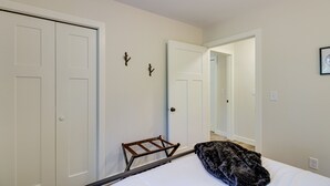 A bedroom with a bed, a wooden ladder, and two doors. - Wadena Vacation Rental ~ 1 Mi to Downtown! (Wadena)