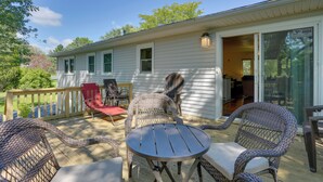 A covered patio with wicker furniture and a small round table. - Kiamesha Lake Home w/ Deck: 4 Mi to Resorts World! (Kiamesha Lake)