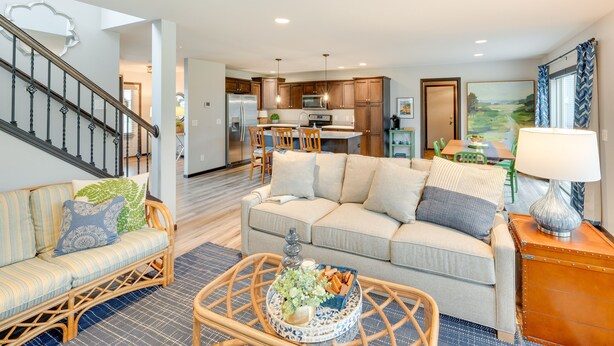 A modern living room with a sofa, coffee table, and a dining area with chairs. - Pet-friendly Deforest Getaway w/ Backyard! (De Forest)