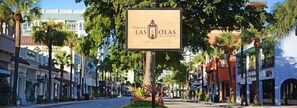 A street view with a sign for 'Las Olas' hotel.