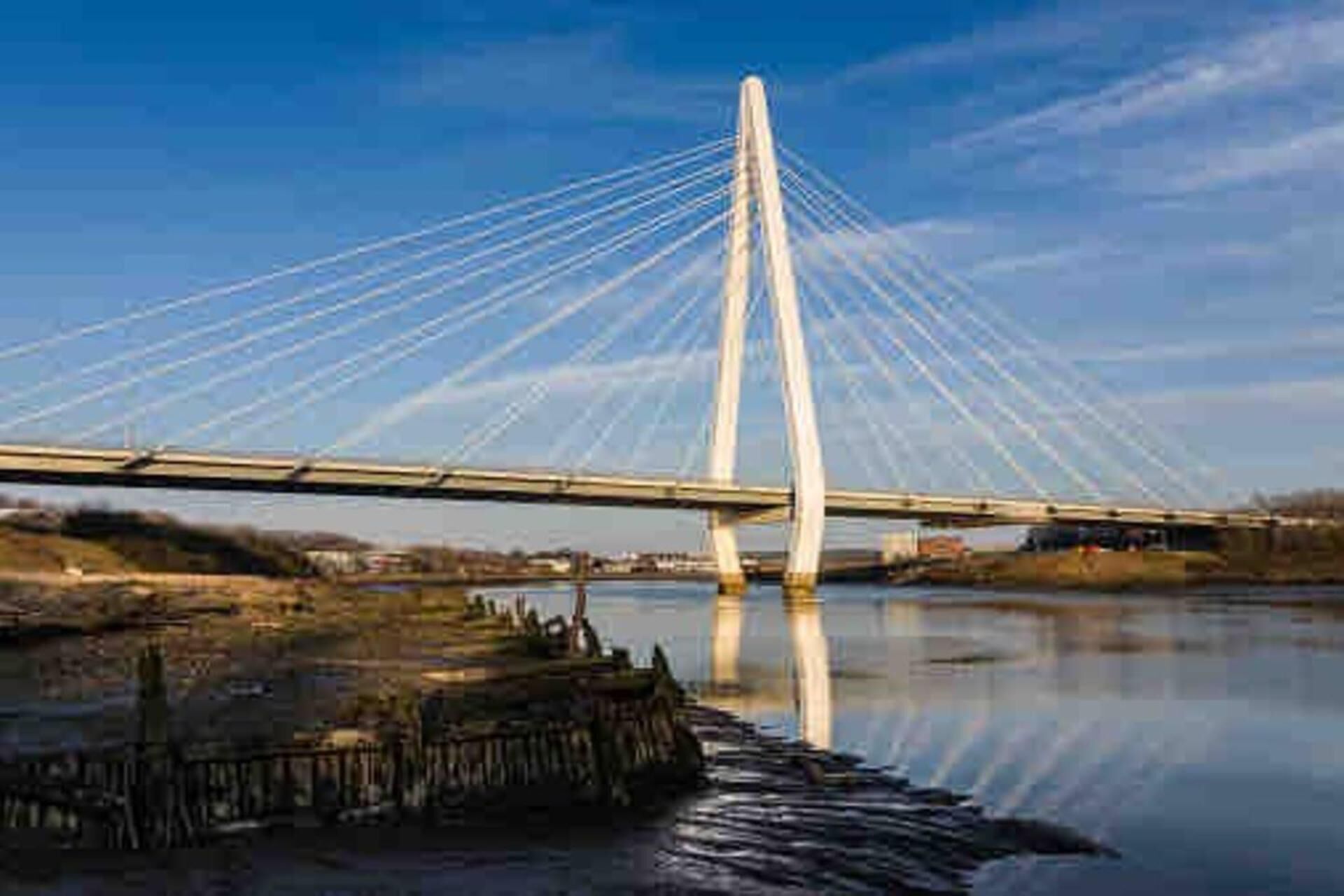 A modern bridge with a central tower and multiple cables.