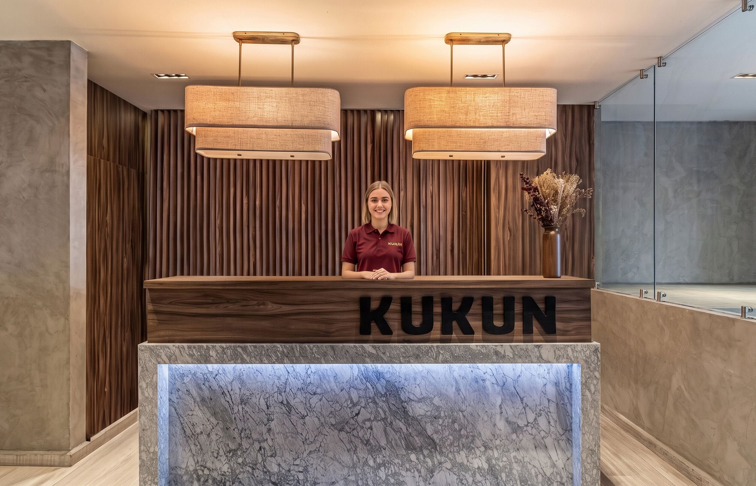 A reception desk with a marble top and the word 'KUKUN' on it.