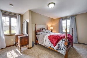 A bedroom with a wooden bed, a nightstand, a dresser, and a window with curtains. - Buskirk Vacation Rental w/ Deck & Putting Green! (Buskirk)