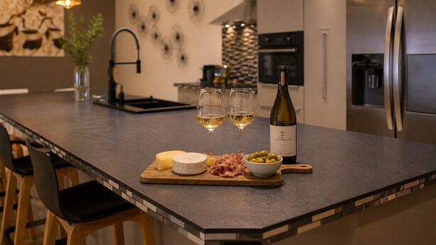 A modern kitchen with a central island, stainless steel appliances, and pendant lighting. - ✨ Loft Evasion – Spacious, Stylish & Family-Friendly near Montpellier & Sea  ✨ (Lattes)