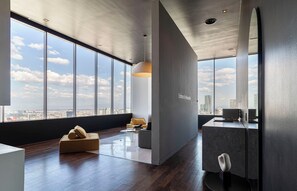 A modern interior with a large window, a sofa, a coffee table, and a minimalist design. - Kukun Escape Santa Fe (Mexico City)