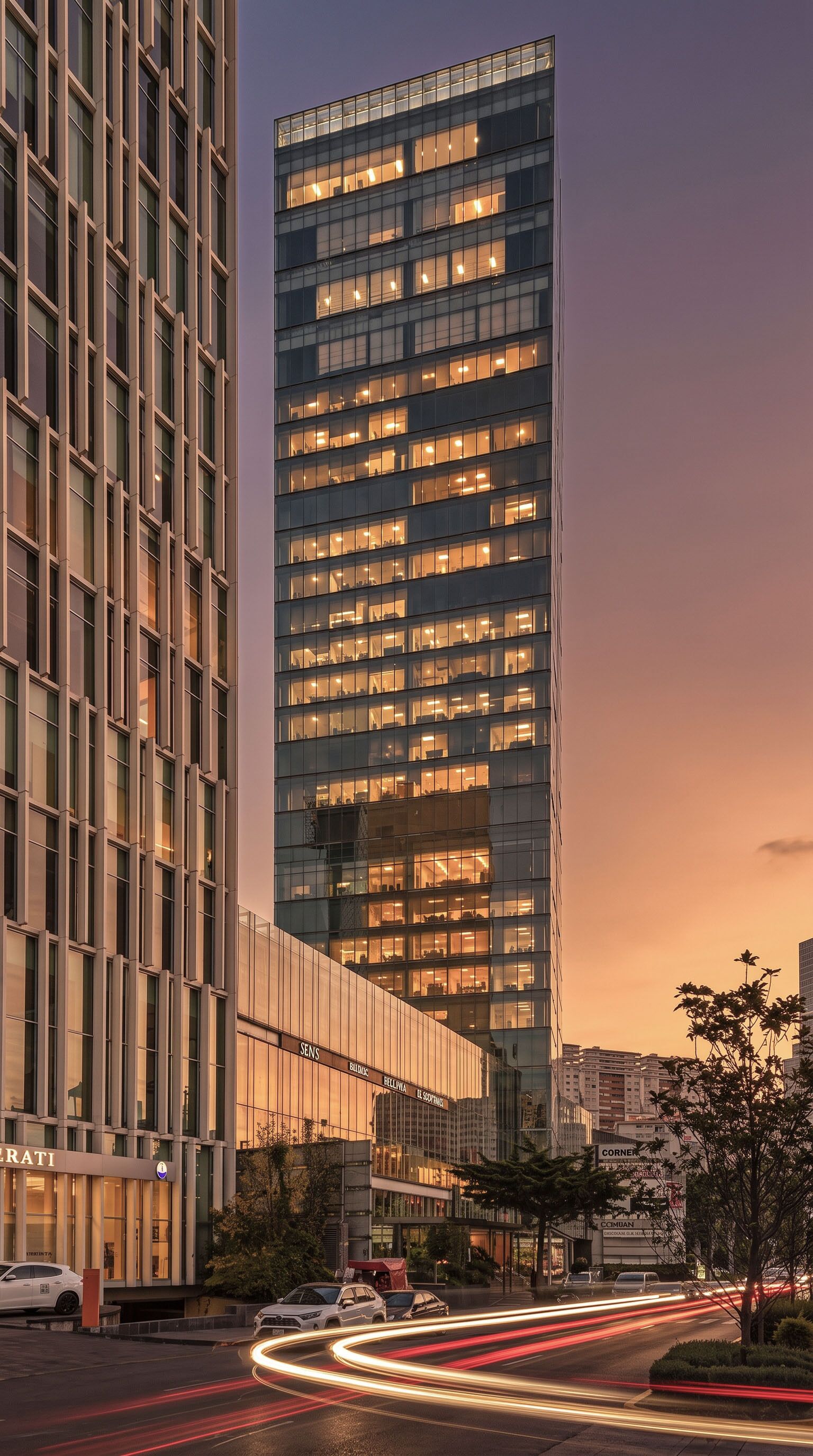 A modern high-rise building with multiple floors and large windows, surrounded by other buildings and a busy street with light trails from moving vehicles.
