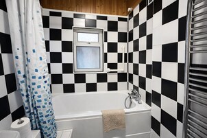 Combined shower/bathtub, deep-soaking bathtub, hair dryer, towels