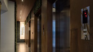 A modern elevator with a digital display showing the number 1.