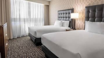 Premium bedding, desk, laptop workspace, blackout drapes