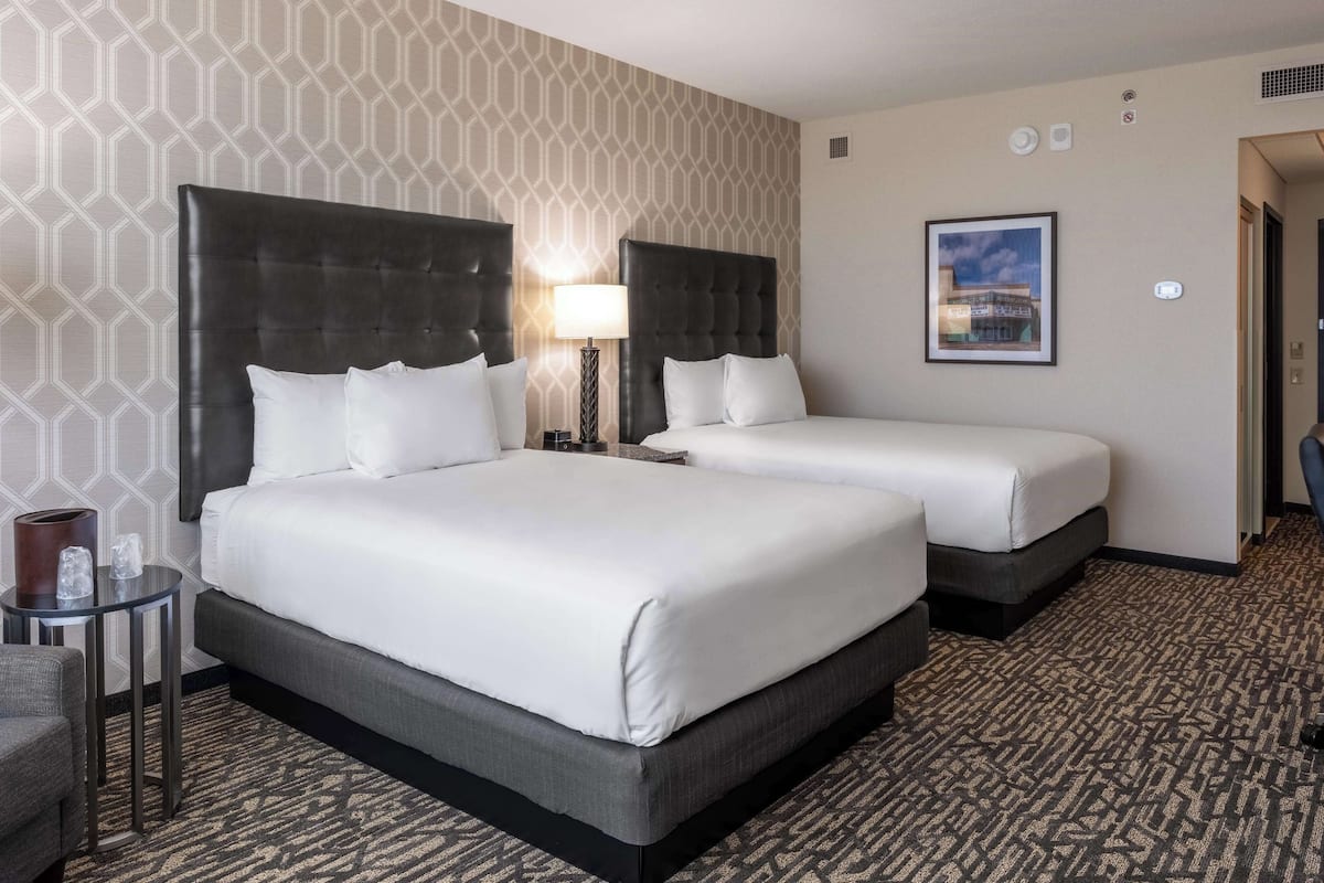 Premium bedding, desk, laptop workspace, blackout drapes