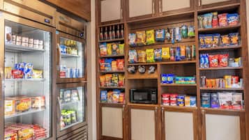 A snack and beverage section with refrigerated and shelf storage, including microwaves and various packaged goods.