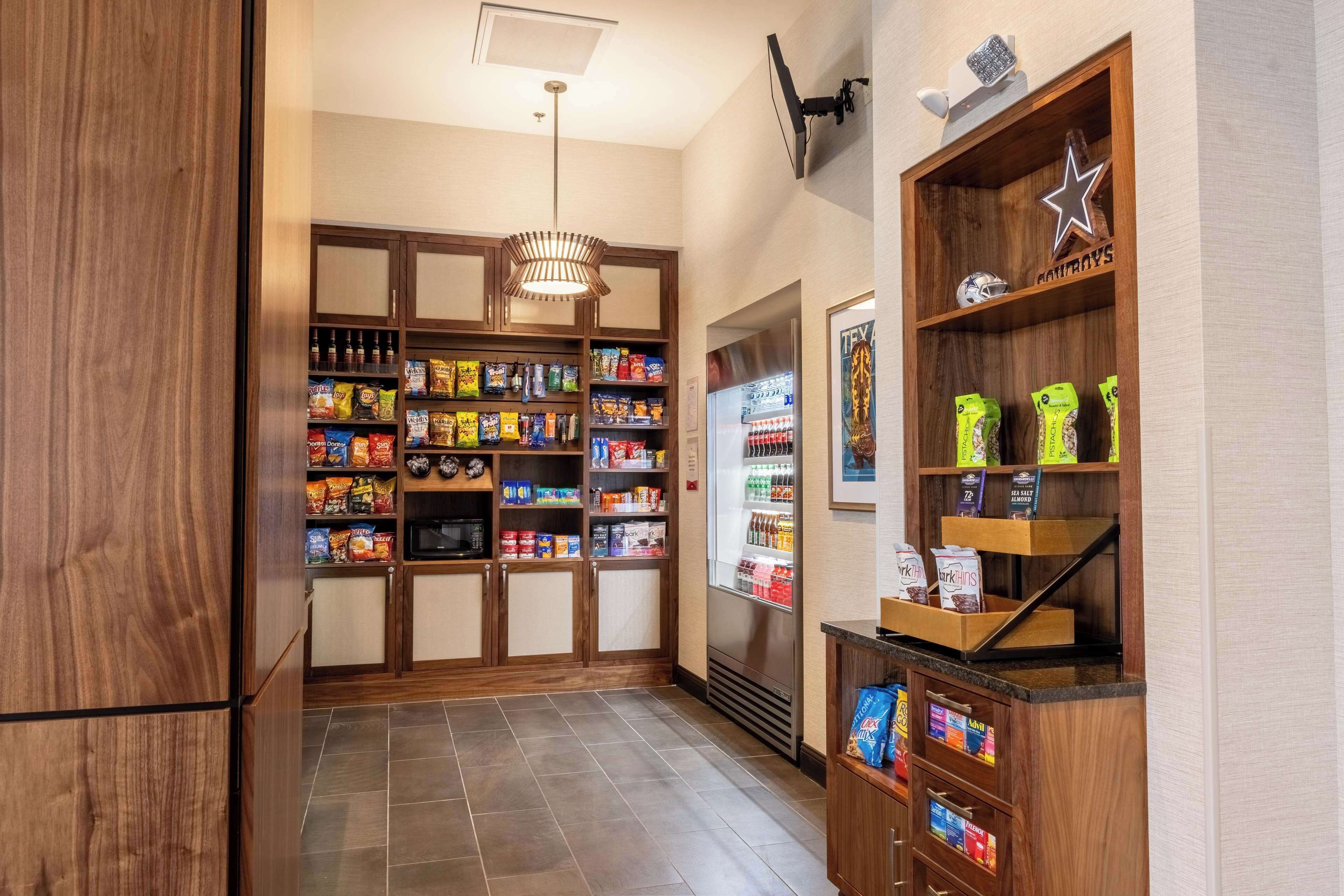 A kitchen with wooden cabinets, a refrigerator, and a coffee machine.
