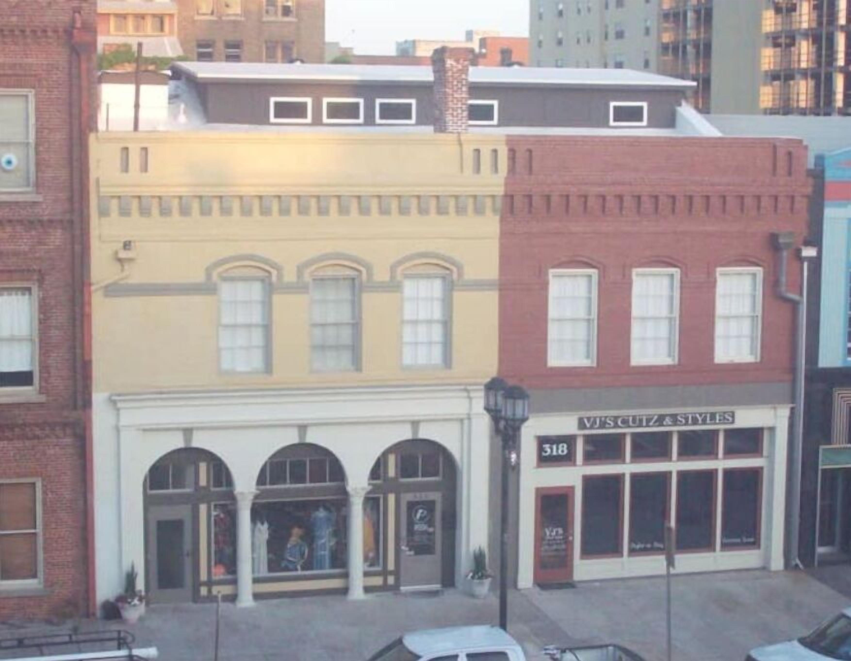 A building with a storefront labeled "VJ'S CUTZ & STYLES" at 318.