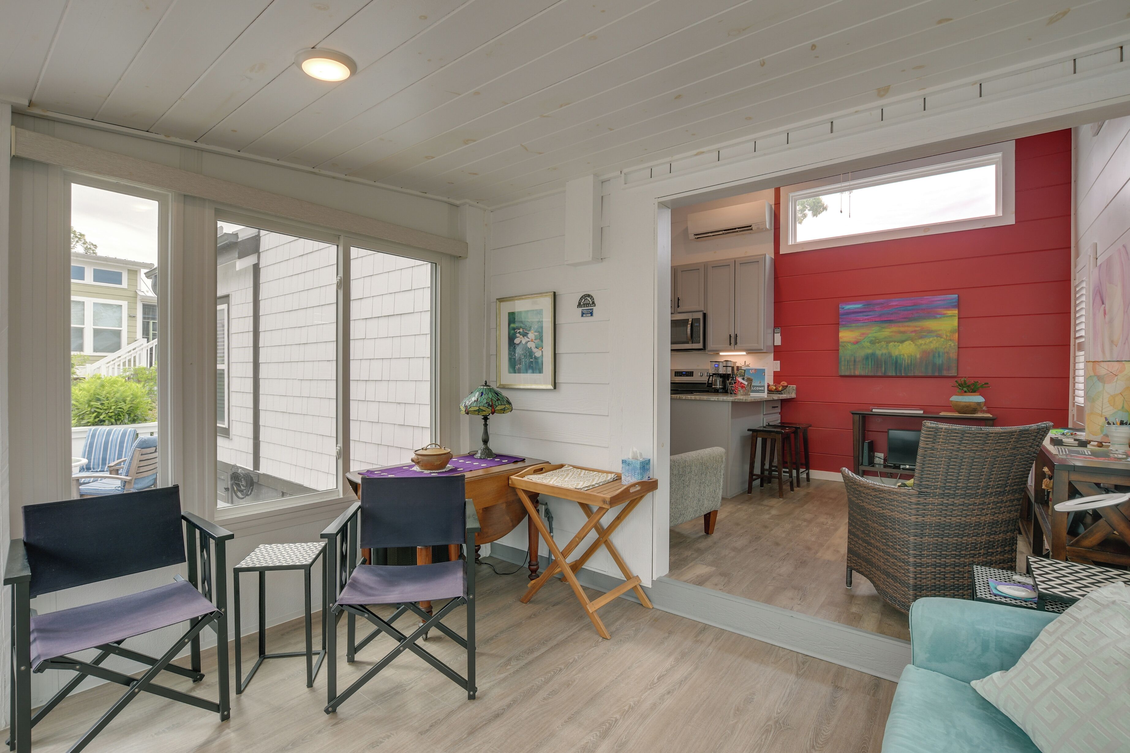 A compact living space with a dining area, kitchen, and seating area.