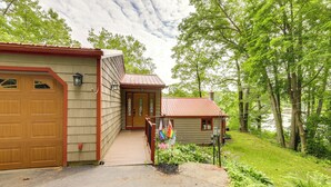 A two-story house with a garage, a front porch, and a small shed. - Lakefront Connecticut Retreat Near Uconn (Coventry)