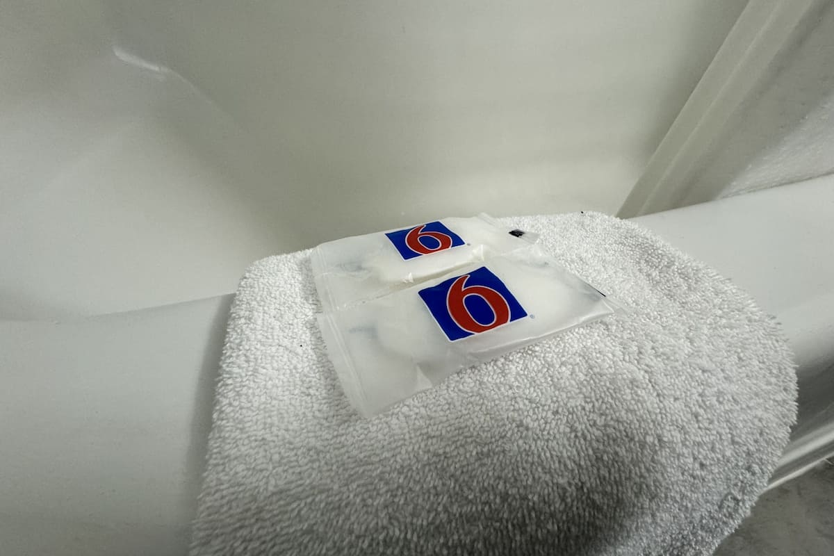 combined shower/bathtub, towels, soap, toilet paper