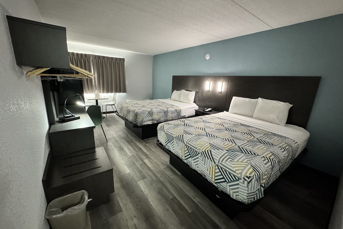 pillow-top beds, desk, laptop workspace, blackout curtains