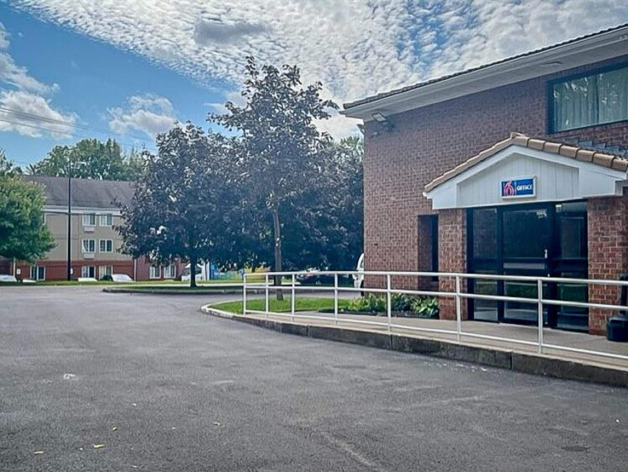 A parking lot with a building labeled "6 COTTAGE" in the background.