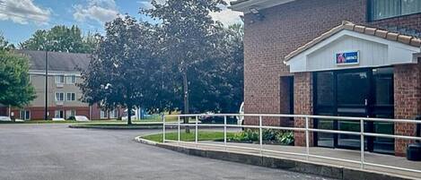 A parking lot with a building labeled "6 COTTAGE" in the background.