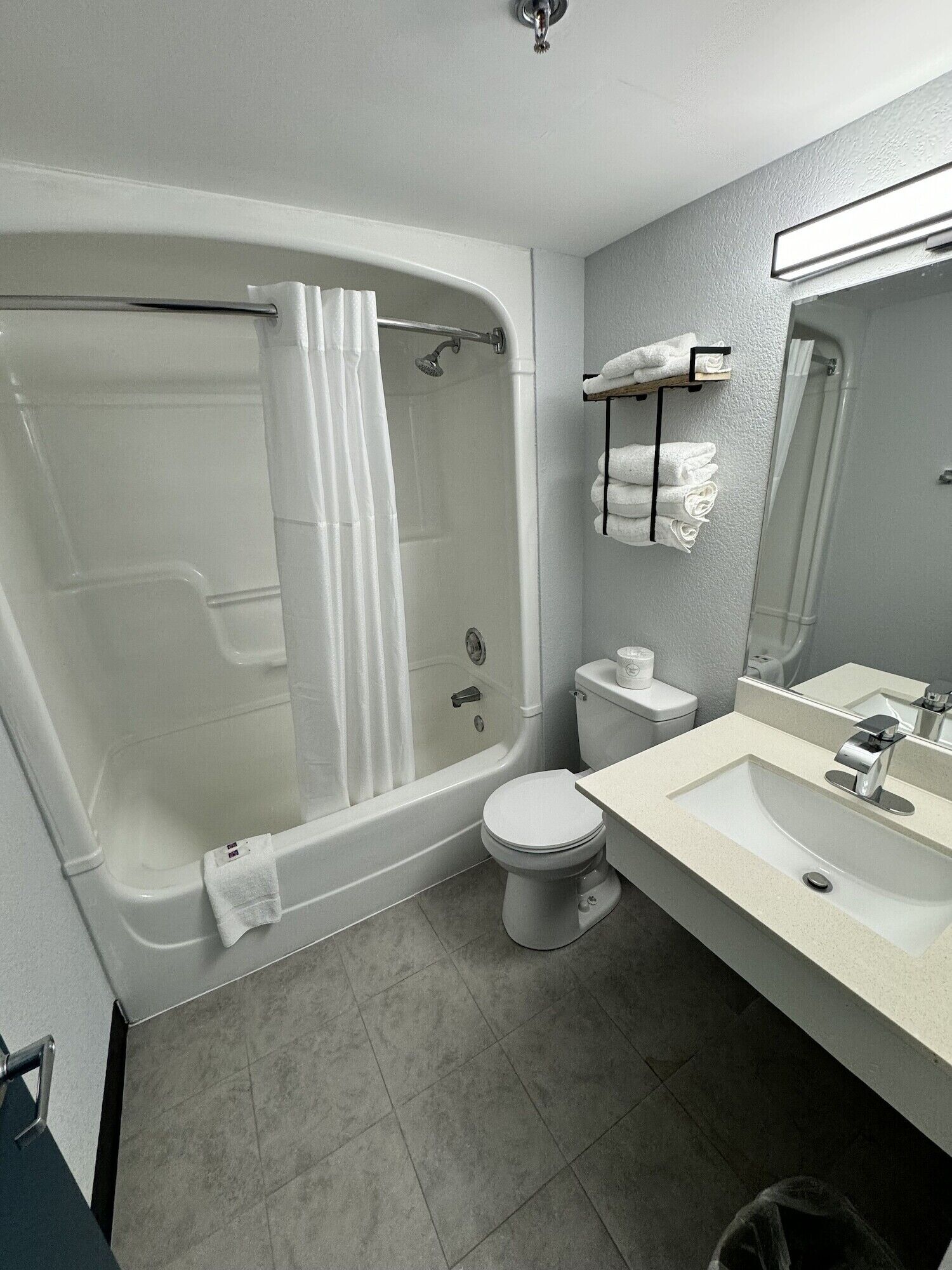 A modern bathroom with a bathtub, toilet, and sink.
