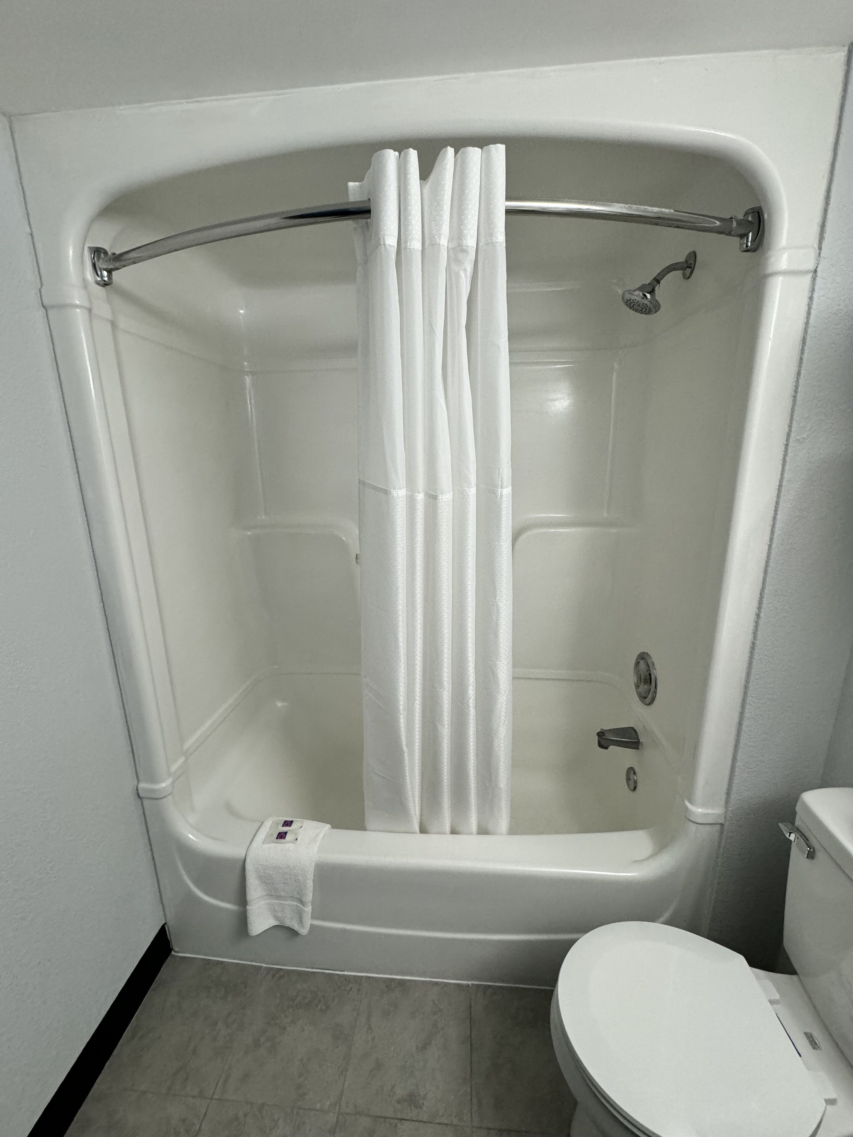 combined shower/bathtub, towels, soap, toilet paper