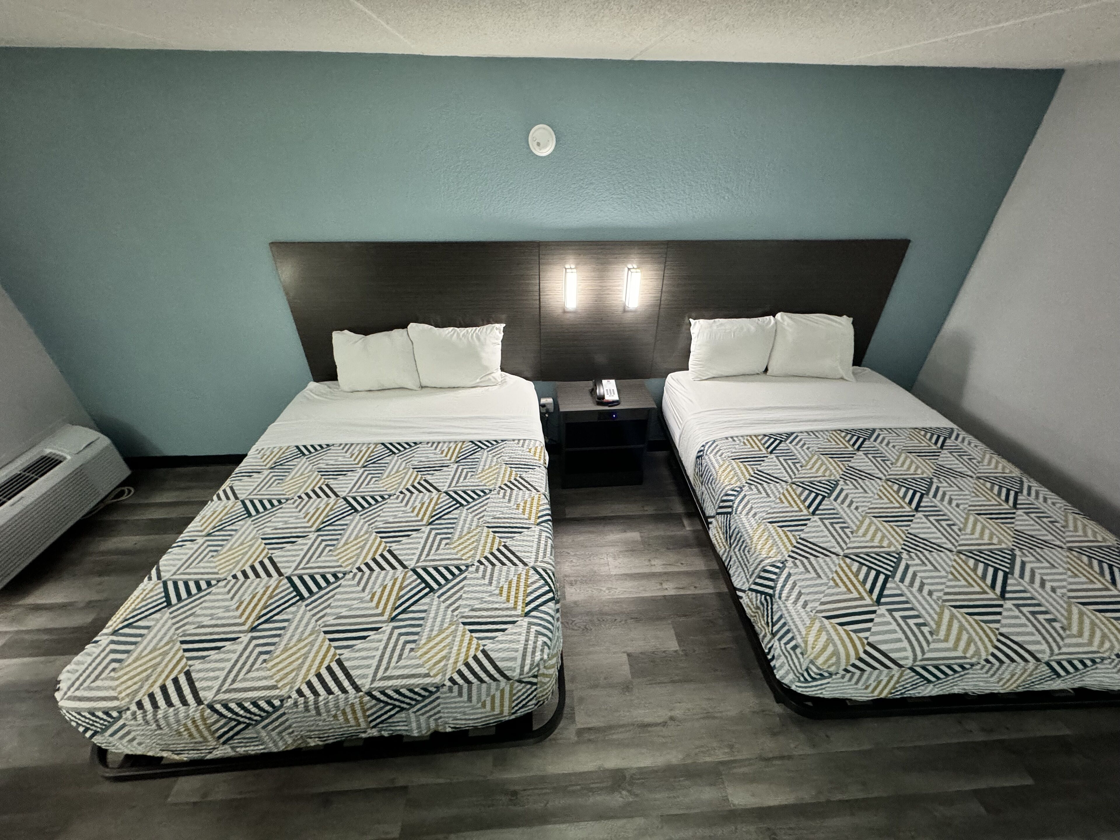 pillow-top beds, desk, laptop workspace, blackout curtains