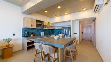 A modern kitchen with a large island, built-in appliances, and a clean, minimalist design.