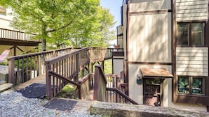 A wooden staircase leading to a building with a balcony, surrounded by trees. - Hike, Ski & Fish! Sunset-View Condo in Beech Mtn (Beech Mountain)