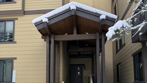 A building entrance with a covered stairway leading to a door. - Fireside Condo at the Village - Sleeps 4 - Newly Remodeled (Mammoth Lakes)