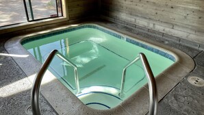 An indoor swimming pool with clear water, a tiled edge, and a metal ladder. - Fireside Condo at the Village - Sleeps 4 - Newly Remodeled (Mammoth Lakes)