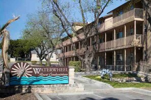 A multi-story building with a sign reading 'Waterwheel Resort Condominiums.'