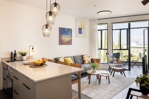 Un espai de vida modern amb illa de cuina, zona de menjador i seients.