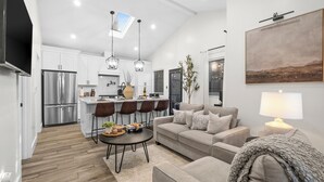 A modern kitchen with a central island, stainless steel appliances, and pendant lighting. - Modern 2-Bed Family Haven 🏡 Pet-Friendly + EV Charging 🐾⚡ (San Jose)