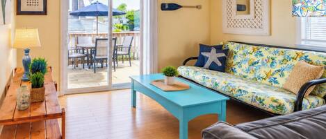 Living Room with full futon and slider to deck