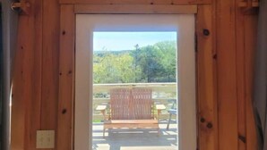 A wooden-framed door leading to an outdoor patio with a bench and a table. - 3BR House Plus Bonus 1BR Apt at The Rockbound House 1Hr to Acadia National Park (Brooklin)