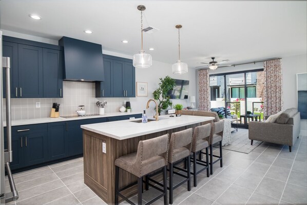 Enjoy casual dining and cooking at the central island with bar stools, offering views of the surrounding landscape.