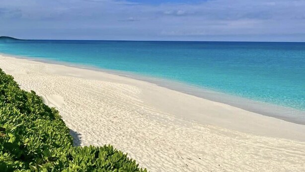 A beach with clear turquoise water and white sand. - Your home away from home (Nassau)