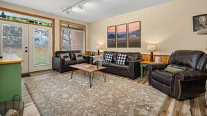 A living room with a sofa, a coffee table, and a lamp.