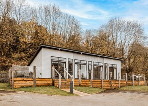 A modern building with large windows, a flat roof, and a wooden deck. - 2 bedroom accommodation in Bridgnorth (Bridgnorth)