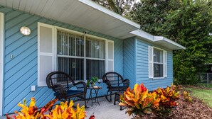 A house with a porch, two rocking chairs, and a small table. - Family Welcome-Large Comfy Stay Pets Welcome w/Parking Trailers/Bikes/Boats (Edgewater)