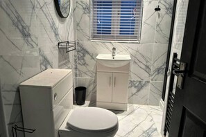 Shower, hair dryer, towels, shampoo